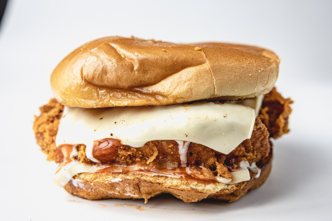 Buffalo ranch chicken sandwich with melted Monterey Jack on a brioche bun
