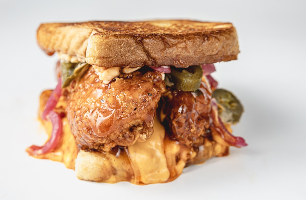 Honey hot chicken sandwich with pickled onions and jalapeños on Texas toast