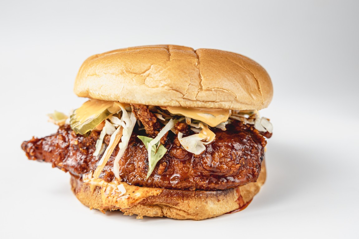 Nashville hot chicken sandwich with coleslaw and pickles on a brioche bun
