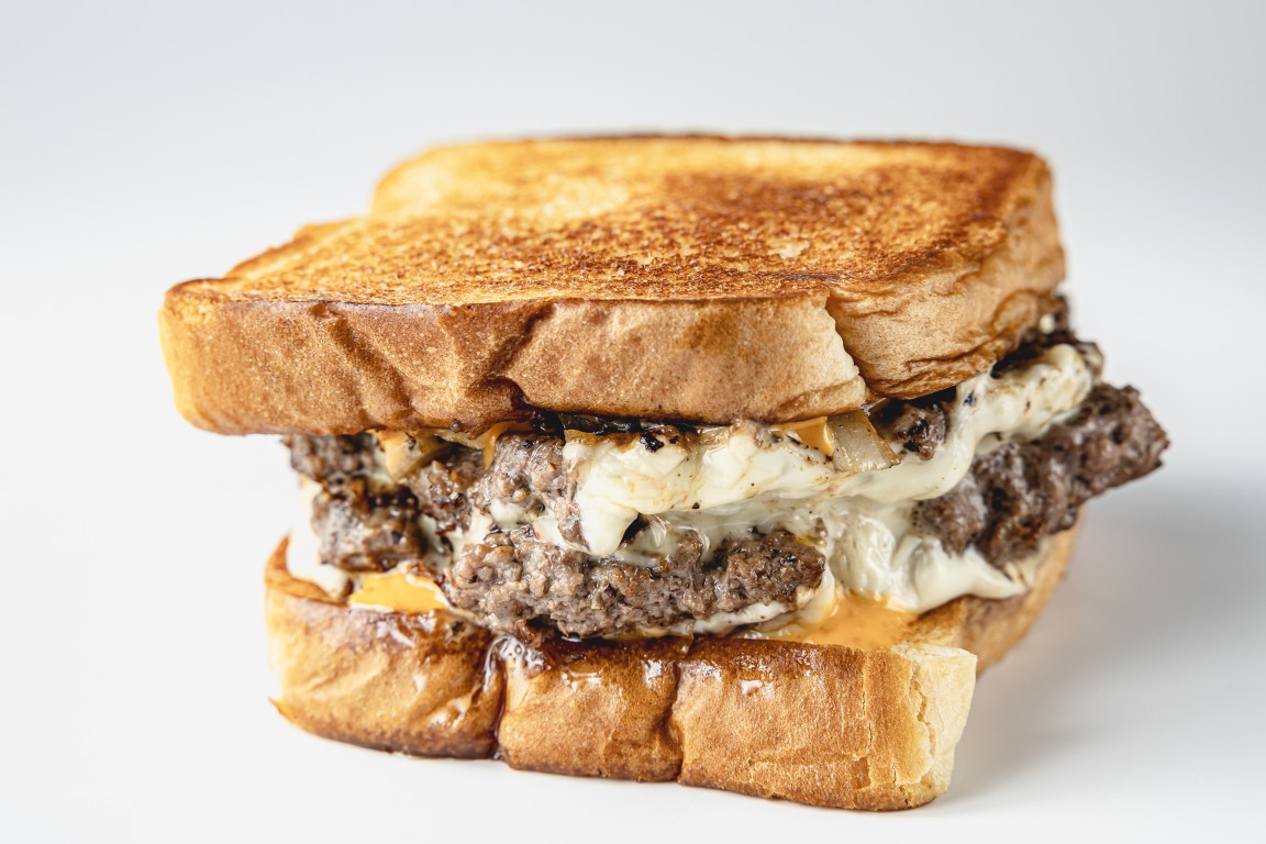 Texas patty melt with grilled onions and melted cheese on Texas toast